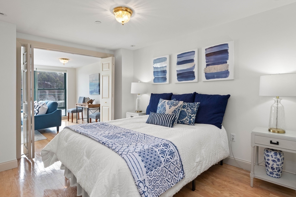 60 Merrimac Street, Unit 907 Amesbury, MA 01913 - Photo 19 of 23 a bed room with a bed and a lamp