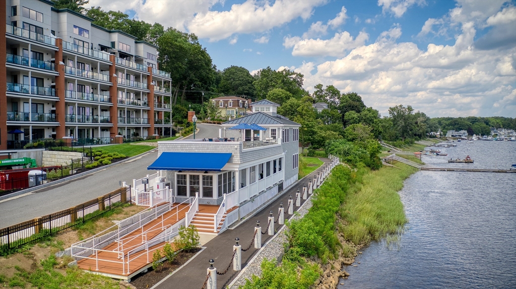 60 Merrimac Street, Unit 907 Amesbury, MA 01913 - Photo 23 of 23 an aerial view of a house with a garden and deck