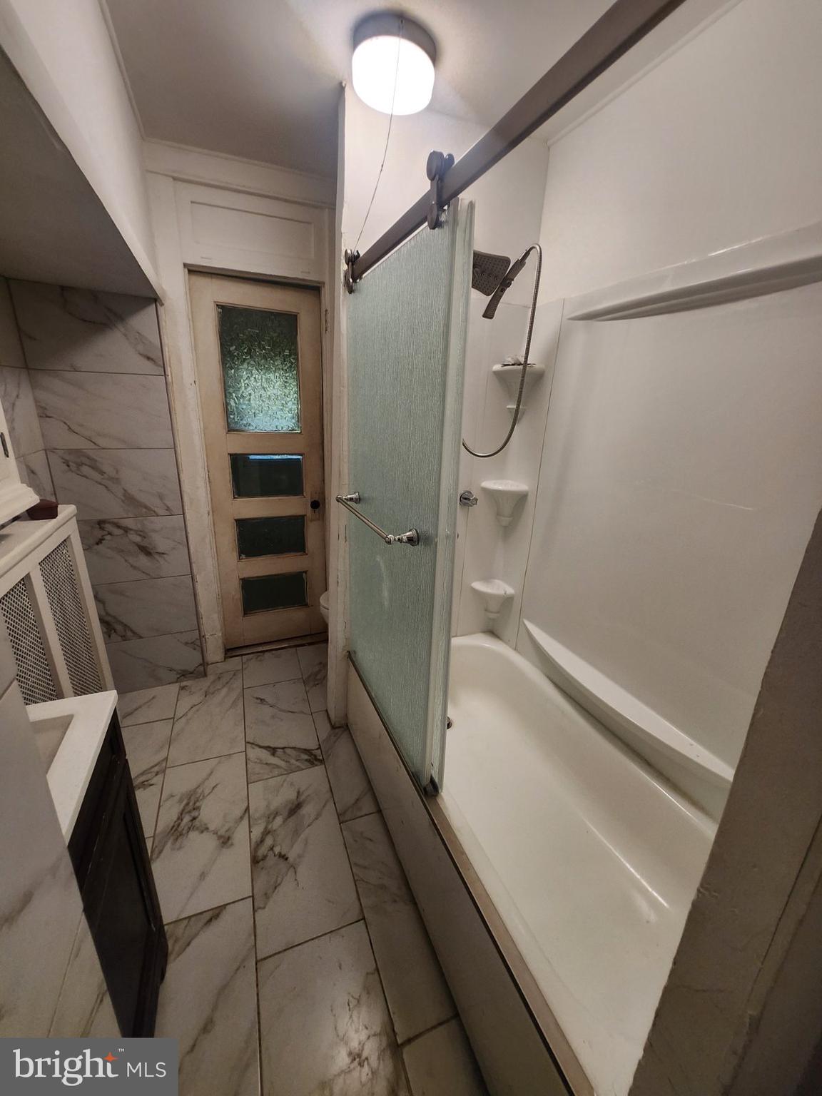 69 South 7th Street Darby, PA 19023 - Photo 15 of 17 a bathroom with a shower and a sink