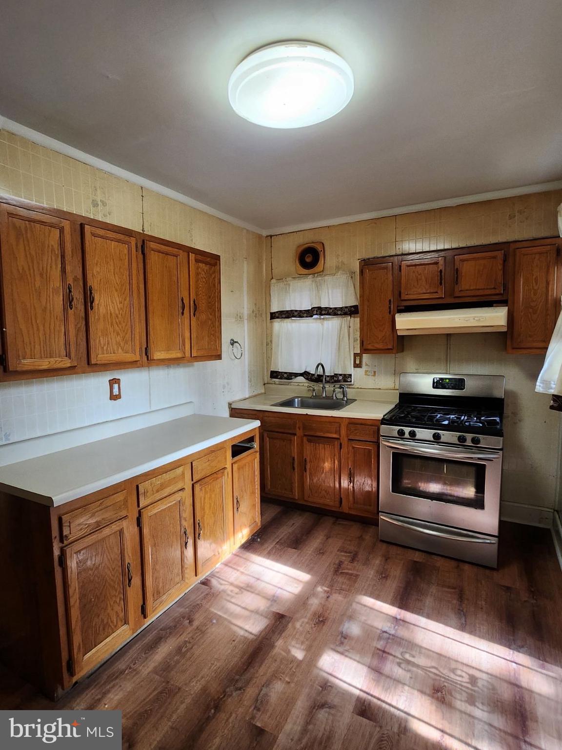 69 South 7th Street Darby, PA 19023 - Photo 3 of 17 a kitchen with stainless steel appliances a stove a sink and a microwave