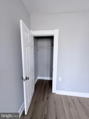 a view of an empty room and wooden floor