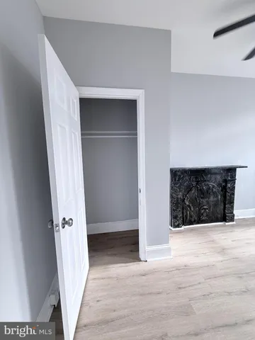 a view of an empty room with wooden floor and staircase