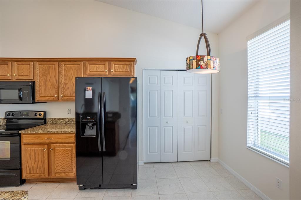 107 Raintree Circle Palm Coast, FL 32164 - Photo 12 of 46 a view of a kitchen with refrigerator and window