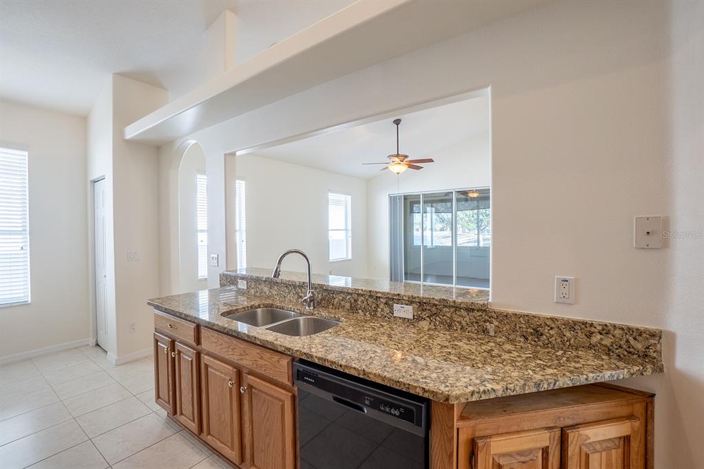 107 Raintree Circle Palm Coast, FL 32164 - Photo 13 of 46 a kitchen with granite countertop a sink and a window