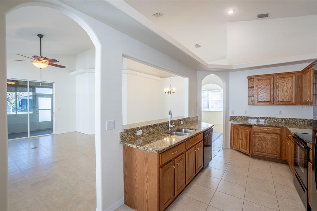 107 Raintree Circle Palm Coast, FL 32164 - Photo 14 of 46 a kitchen with stainless steel appliances granite countertop a stove and a sink