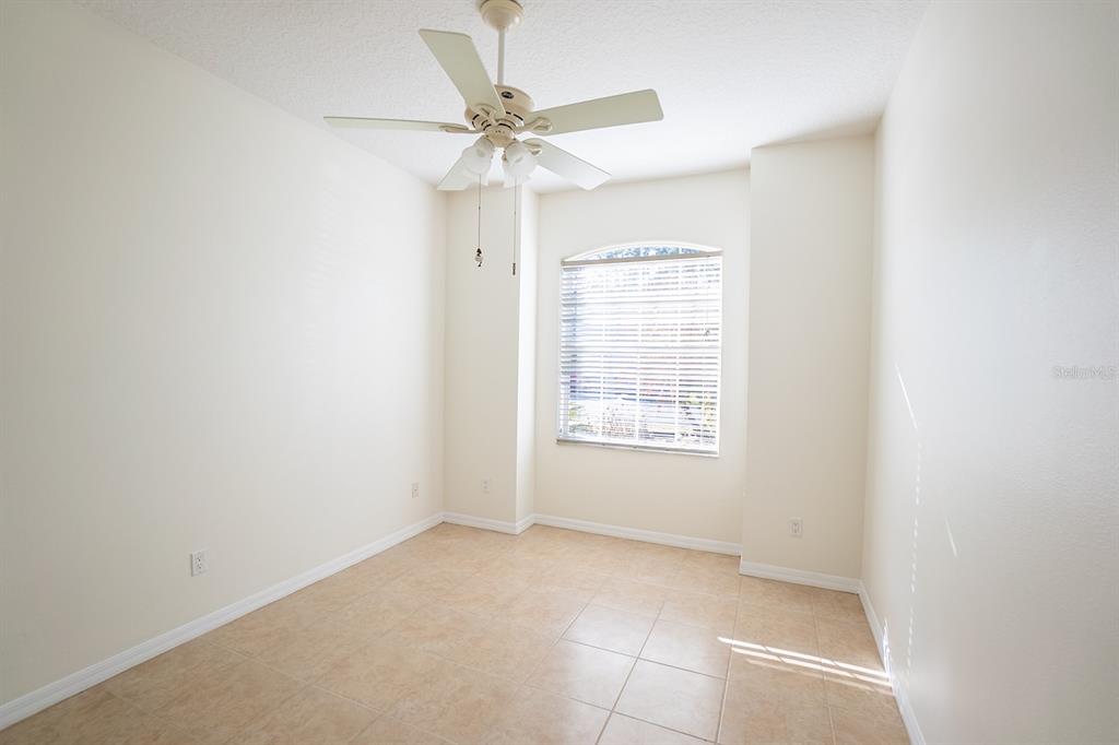 107 Raintree Circle Palm Coast, FL 32164 - Photo 15 of 46 an empty room with a window and a fan