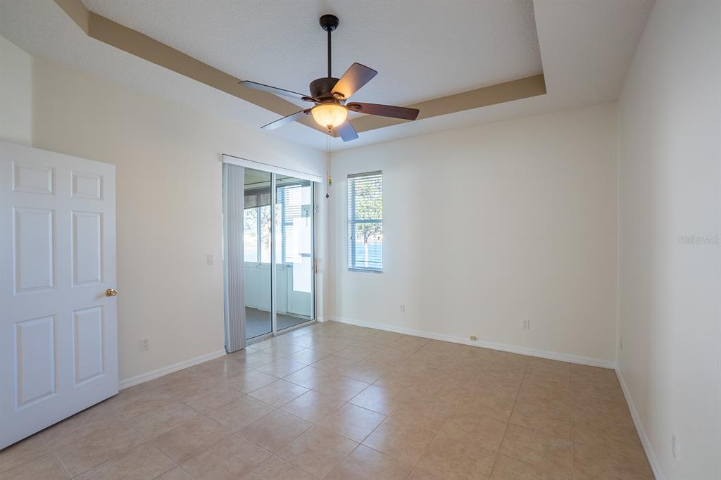 107 Raintree Circle Palm Coast, FL 32164 - Photo 36 of 46 an empty room with a window and a ceiling fan