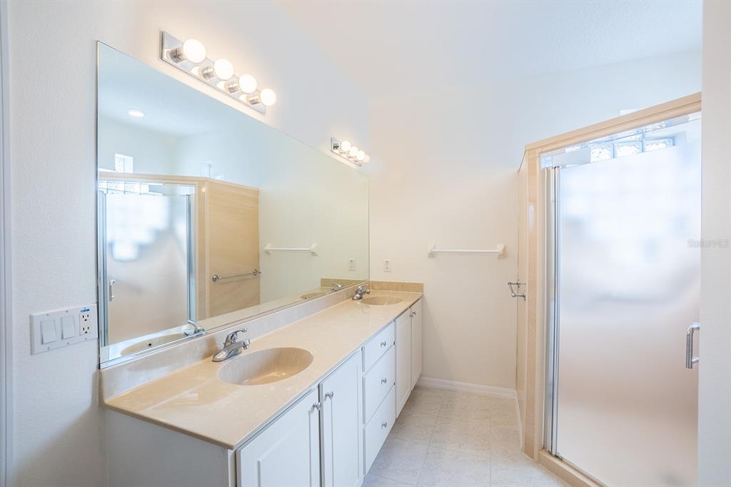 107 Raintree Circle Palm Coast, FL 32164 - Photo 38 of 46 a bathroom with a sink double vanity and a mirror