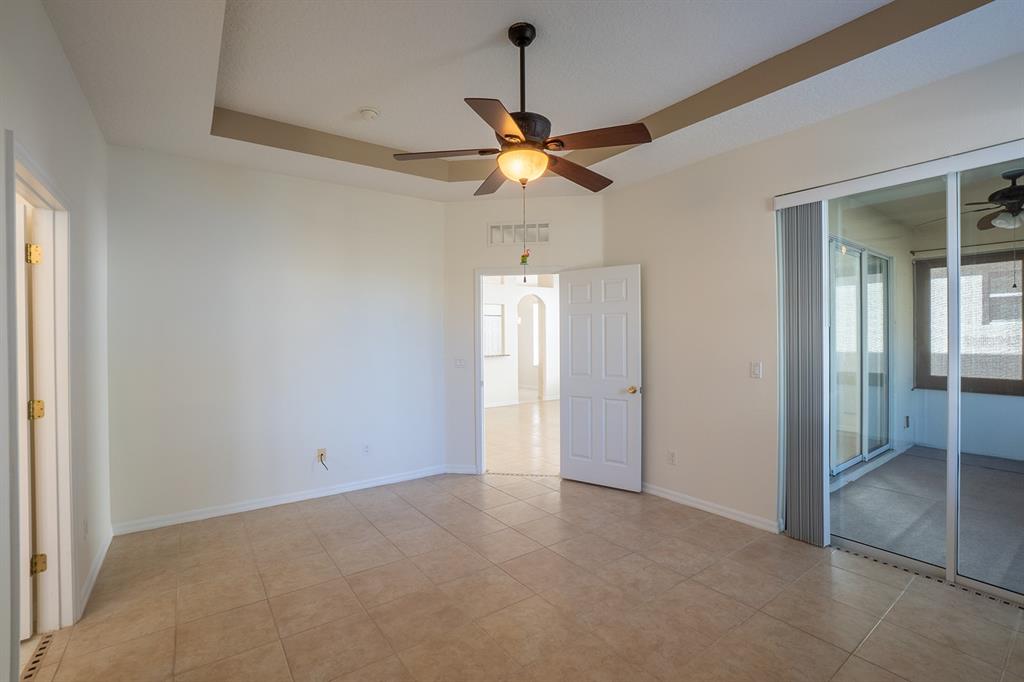 107 Raintree Circle Palm Coast, FL 32164 - Photo 39 of 46 a view of an empty room and window chandelier fan