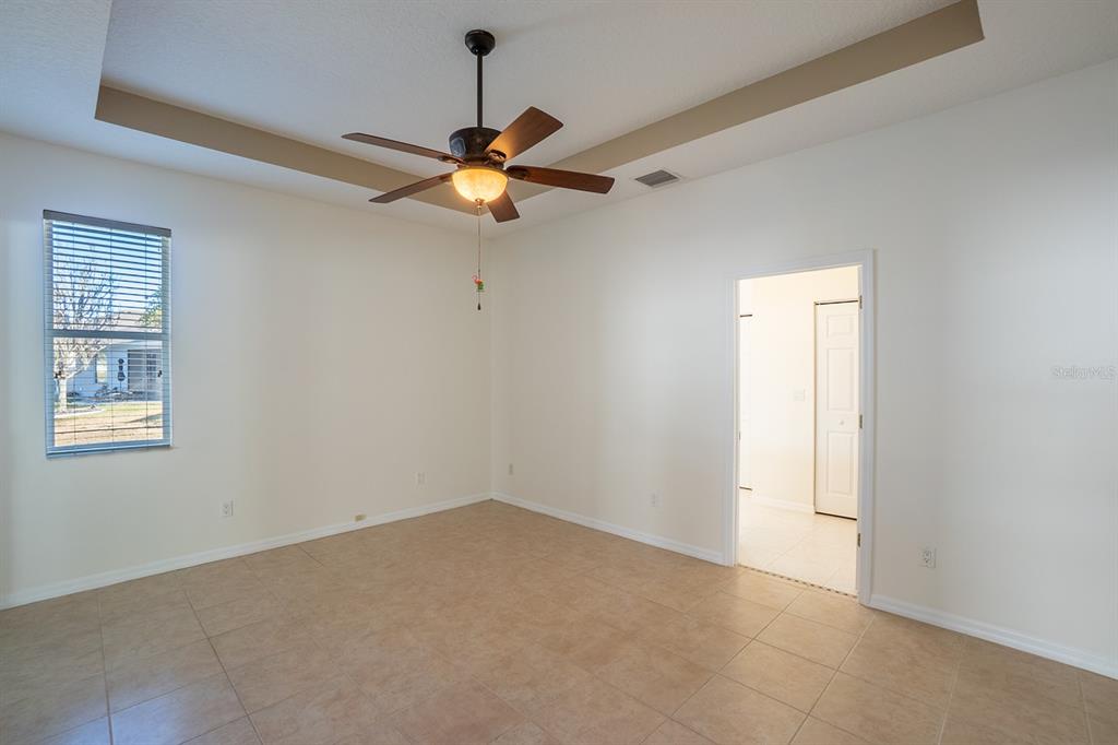 107 Raintree Circle Palm Coast, FL 32164 - Photo 40 of 46 an empty room with a window and a fan