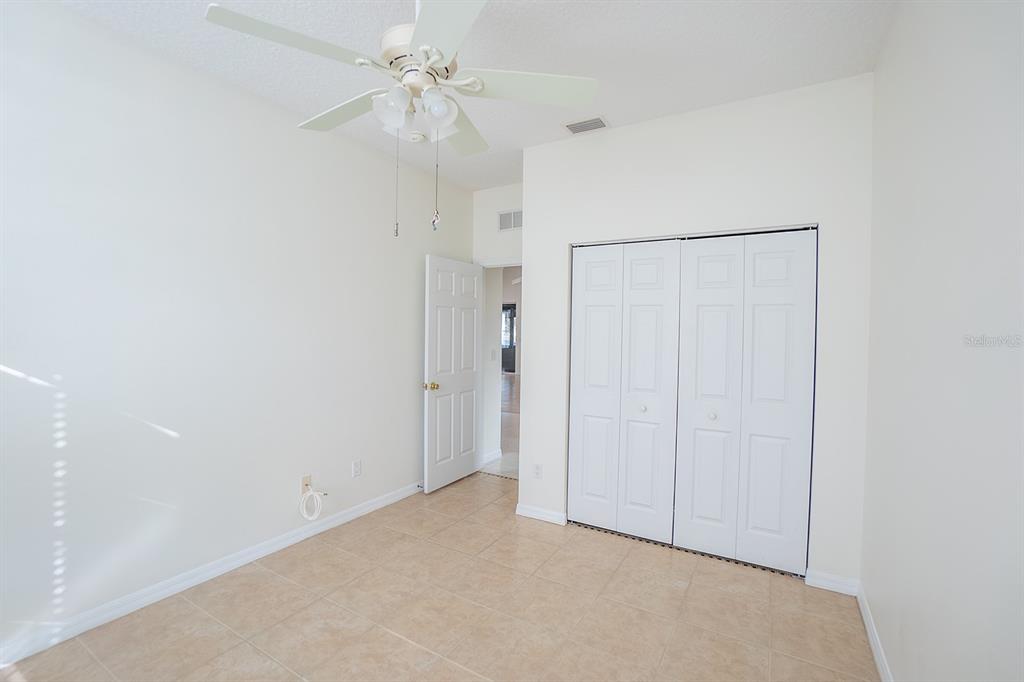 107 Raintree Circle Palm Coast, FL 32164 - Photo 42 of 46 an empty room with a ceiling fan and a window