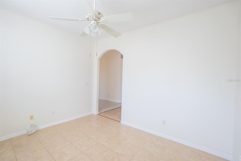 107 Raintree Circle Palm Coast, FL 32164 - Photo 43 of 46 an empty room with a fan & a ceiling fan