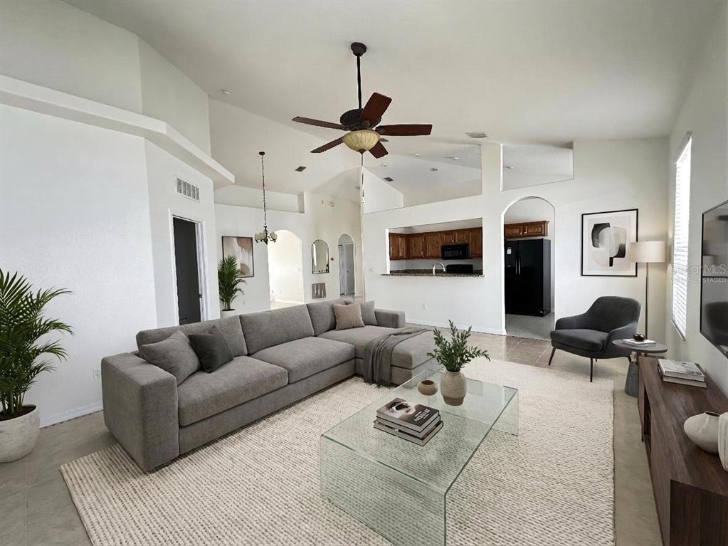 107 Raintree Circle Palm Coast, FL 32164 - Photo 46 of 46 a living room with furniture ceiling fan and a rug