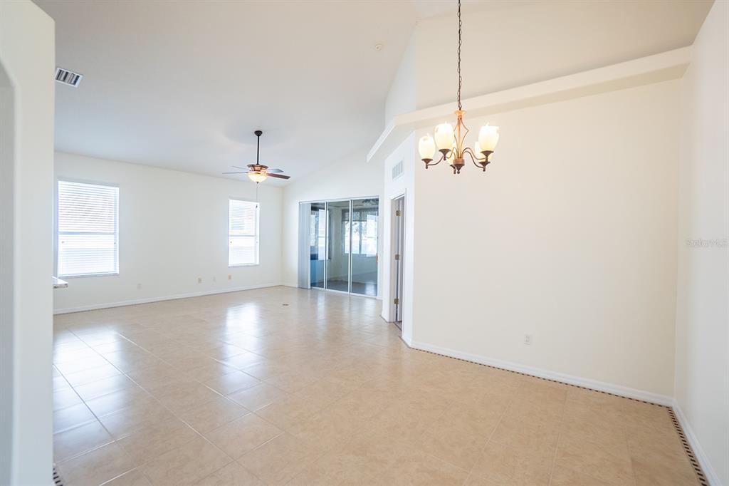 107 Raintree Circle Palm Coast, FL 32164 - Photo 8 of 46 a view of a room with window and wooden floor
