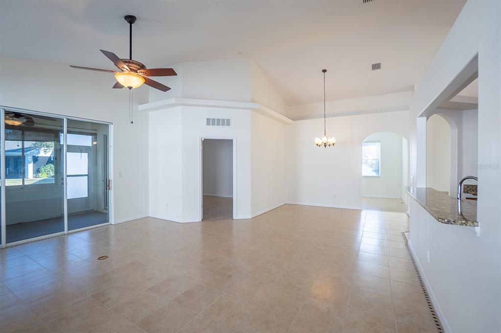 107 Raintree Circle Palm Coast, FL 32164 - Photo 9 of 46 a view of a livingroom with a ceiling fan and window