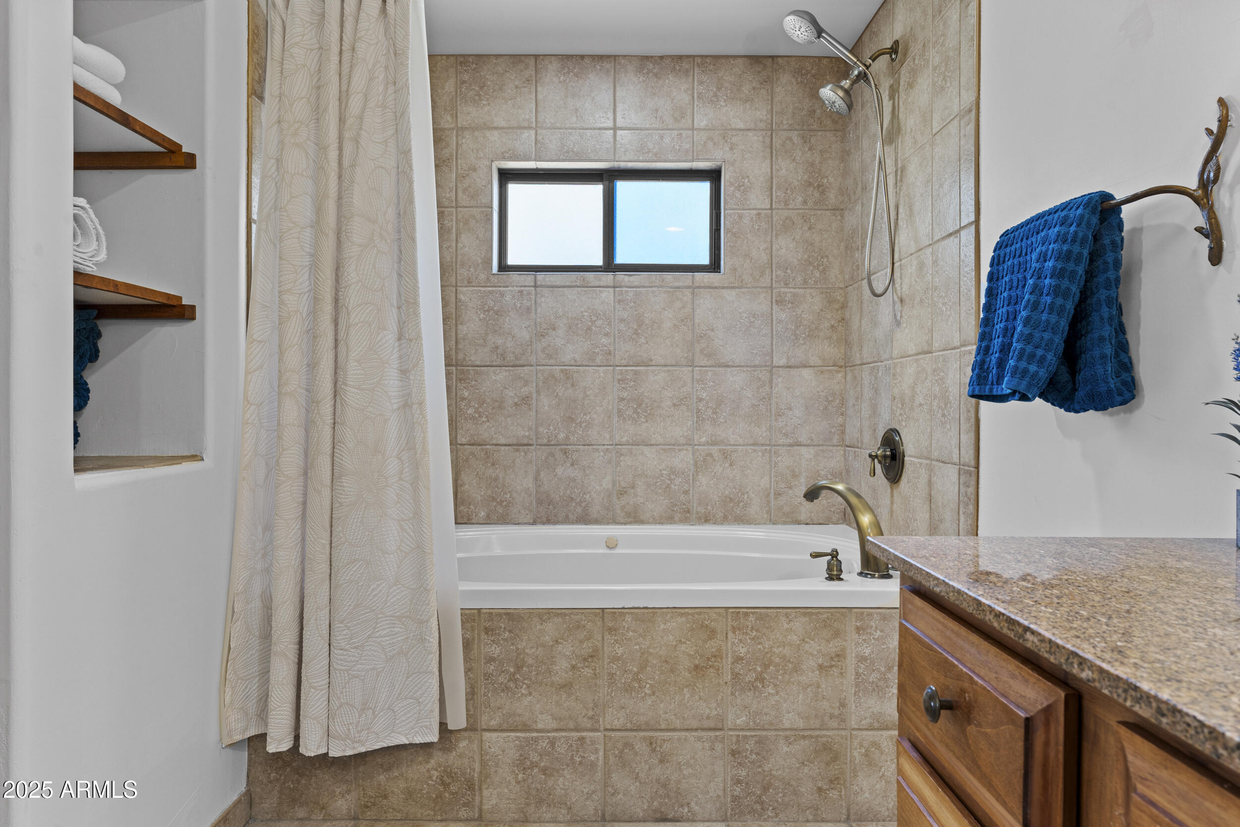 36601 North Mule Train Road, Unit D18 Carefree, AZ 85377 - Photo 22 of 53 a bathroom with a granite countertop bathtub a shower and a vanity