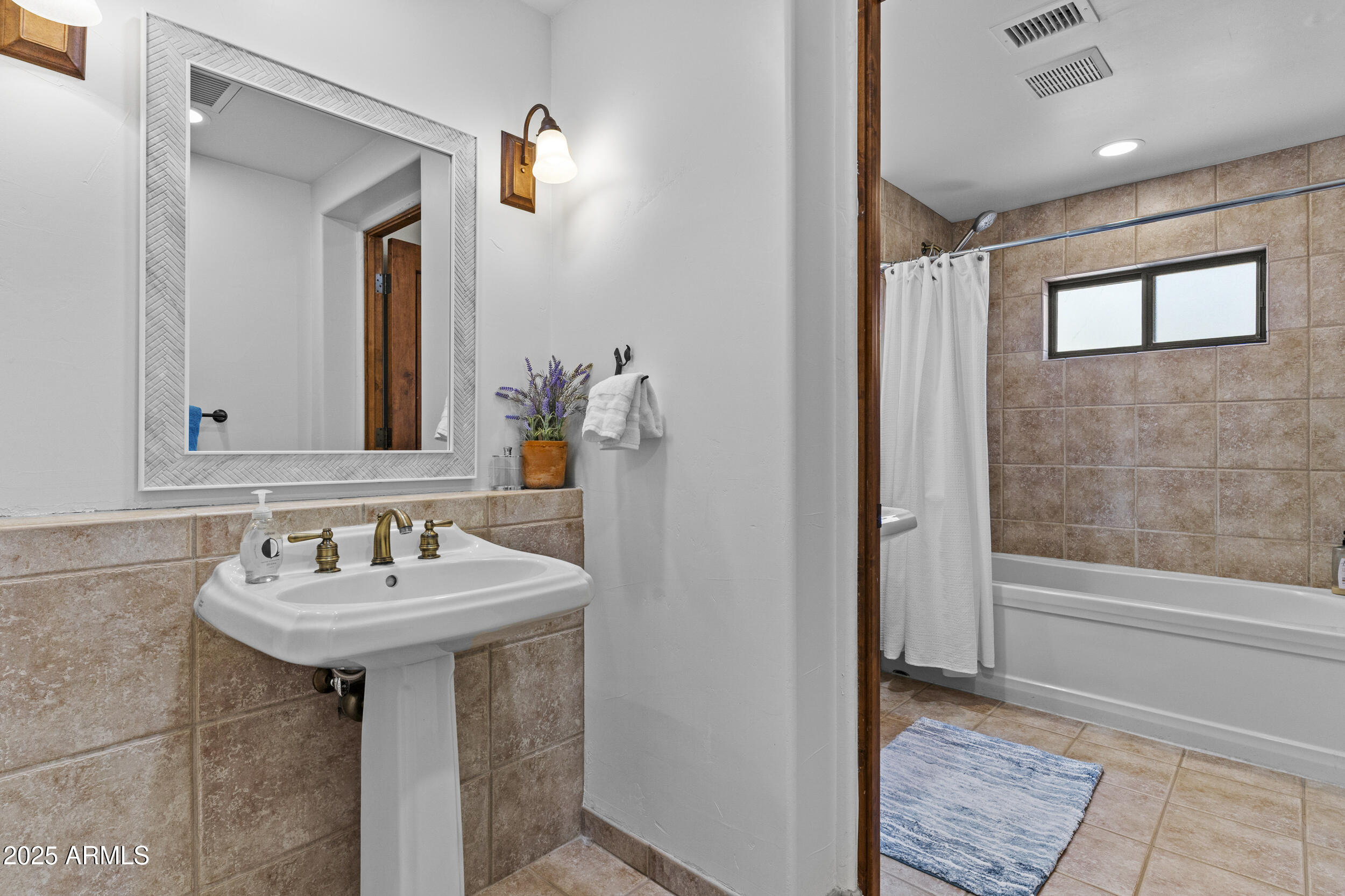 36601 North Mule Train Road, Unit D18 Carefree, AZ 85377 - Photo 35 of 53 a bathroom with a sink and a mirror