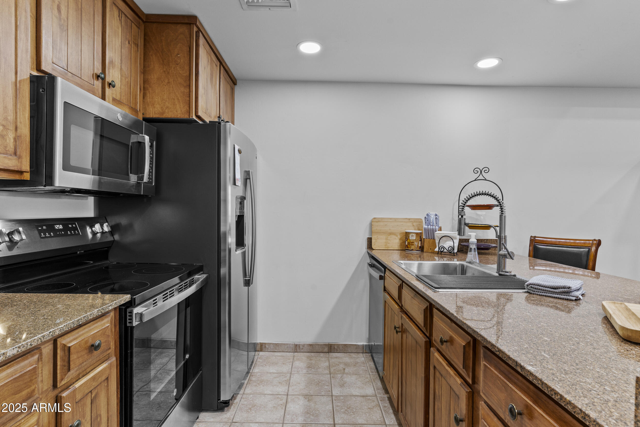 36601 North Mule Train Road, Unit D18 Carefree, AZ 85377 - Photo 4 of 53 a kitchen with stainless steel appliances granite countertop a sink stove and refrigerator