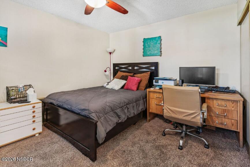 923 North N Place Lompoc, CA 93436 - Photo 11 of 18 a bedroom with a bed and a computer on the desk