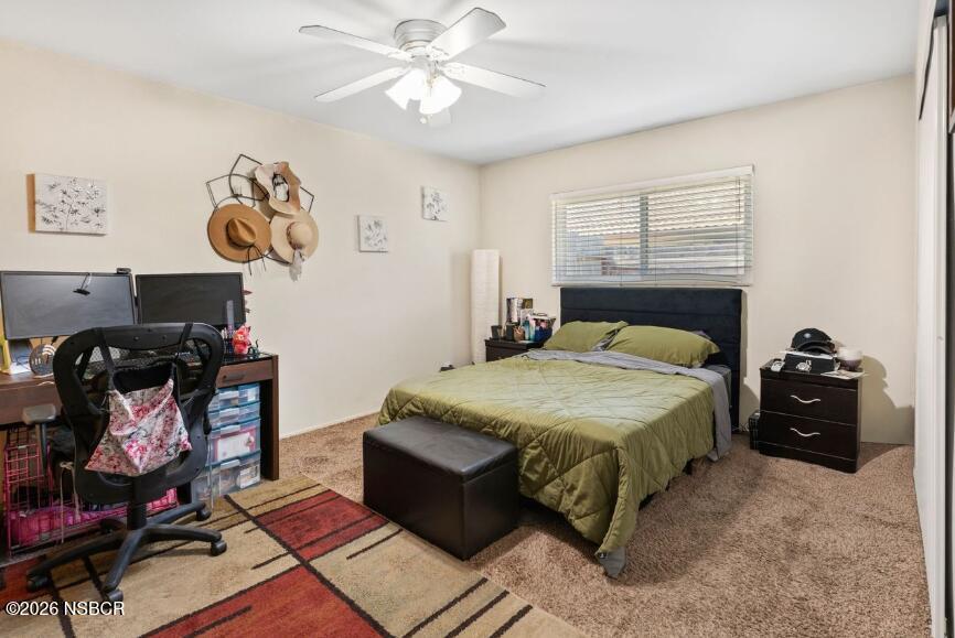 923 North N Place Lompoc, CA 93436 - Photo 14 of 18 a bedroom with a bed and a chandelier