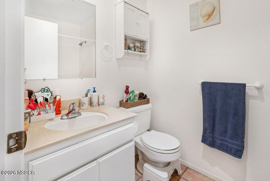 923 North N Place Lompoc, CA 93436 - Photo 10 of 18 a bathroom with a sink vanity mirror and toilet