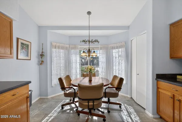 a dining room with furniture a chandelier and window