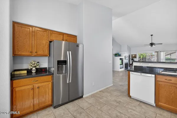 a kitchen with stainless steel appliances granite countertop a refrigerator and a stove top oven
