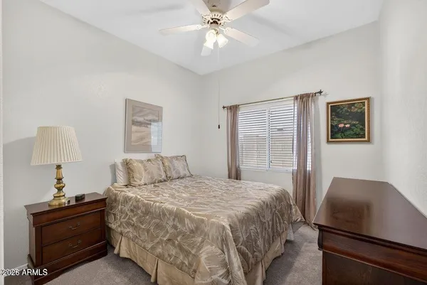 a bedroom with a bed and a desk