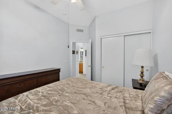 a bedroom with a bed and a window