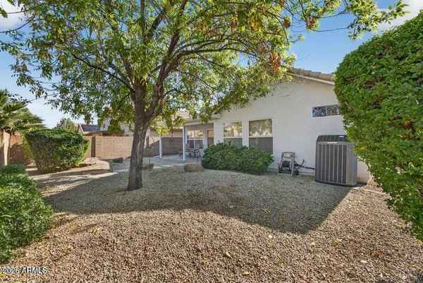a view of a house with a tree in the background