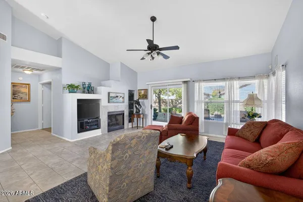 a living room with furniture a fireplace and a chandelier