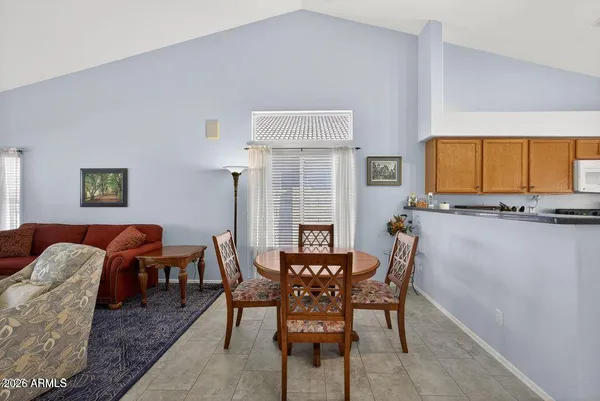 a view of a dining room with furniture and a window