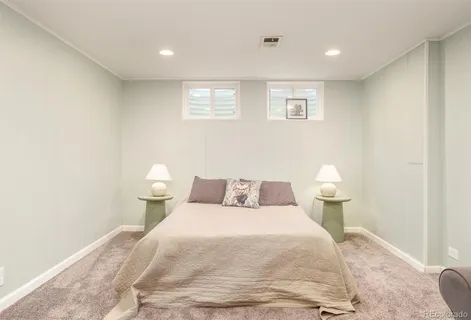 a bedroom with a bed and a night stand