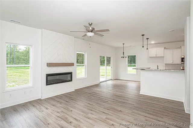 a view of a kitchen with wooden floor and a kitchen
