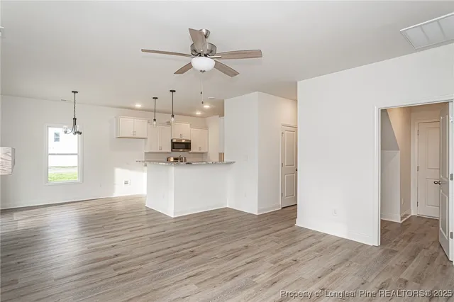 a view of a kitchen with a refrigerator and window