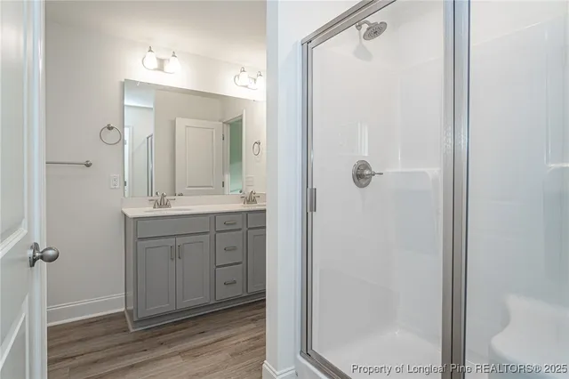 a bathroom with a granite countertop sink mirror and a toilet