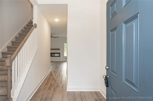 a view of a hallway view with wooden floor and staircase
