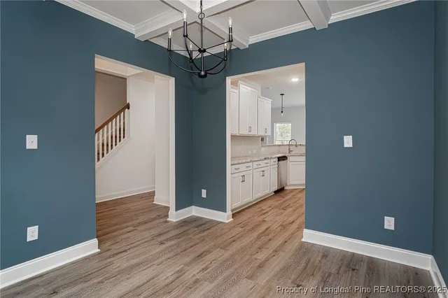 a view of a kitchen with a sink and wooden floor