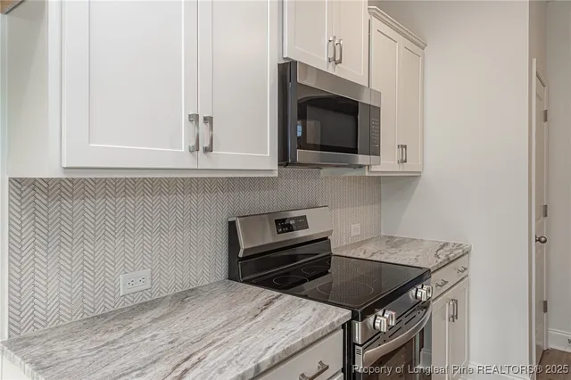 a kitchen with a stove and a microwave