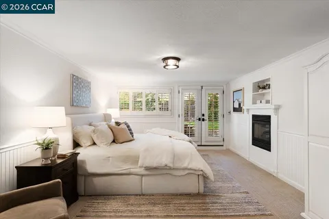 a bedroom with a large bed and white walls