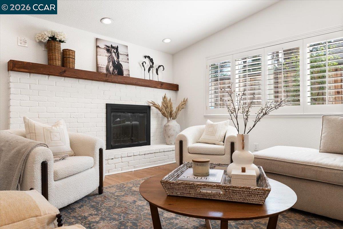 4175 Pickwick Drive Concord, CA 94521 - Photo 22 of 41 a living room with furniture a fireplace and a large window