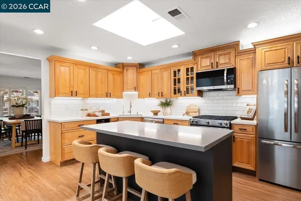 a kitchen with granite countertop a counter space a sink appliances and cabinets