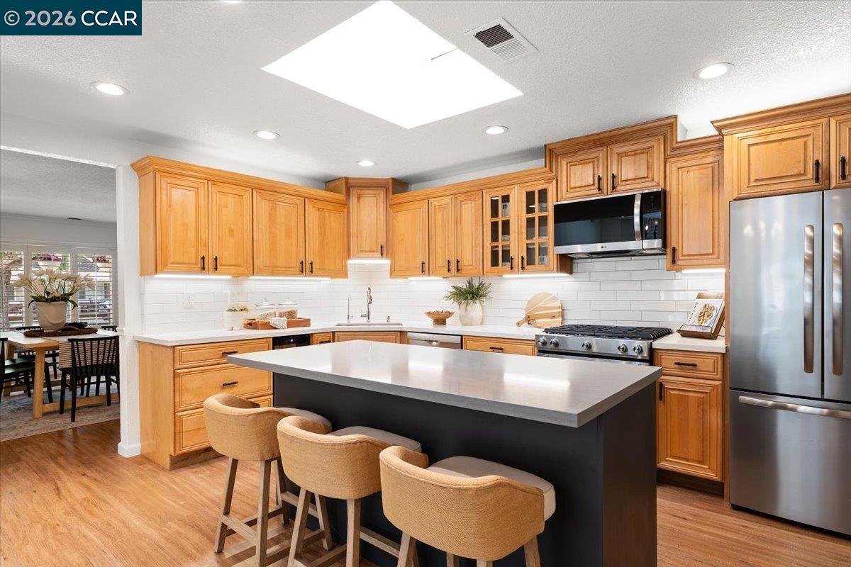 4175 Pickwick Drive Concord, CA 94521 - Photo 3 of 41 a kitchen with granite countertop a counter space a sink appliances and cabinets