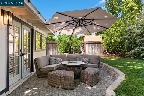 a view of a patio with couches and potted plants