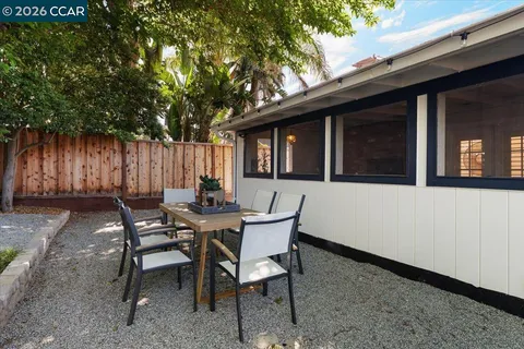 a view of a house with backyard and sitting area