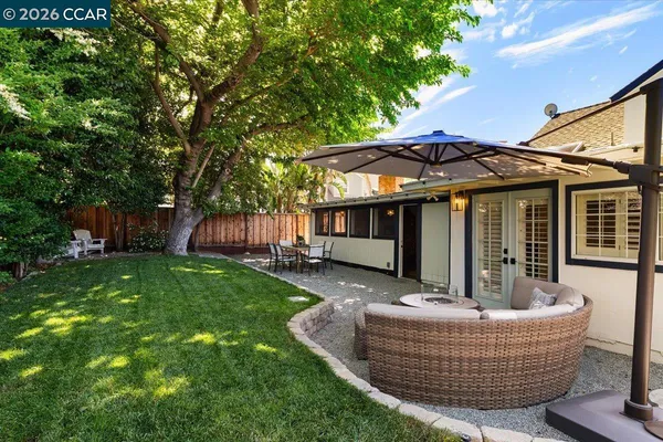 a view of a house with backyard and sitting area