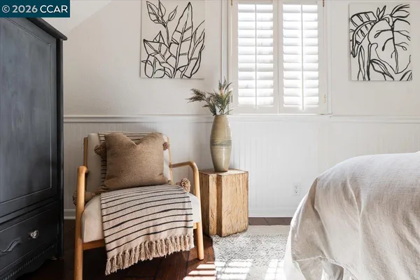 a bedroom with a large bed and white walls