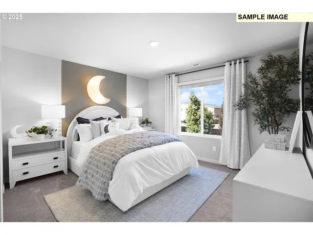 a bedroom with a large bed and a large window