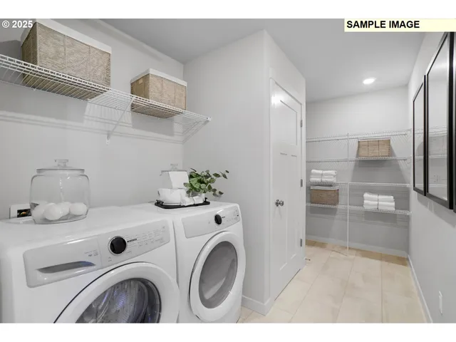 a utility room with sink dryer and washer