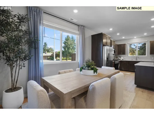 a living room with stainless steel appliances kitchen island granite countertop furniture and a large window
